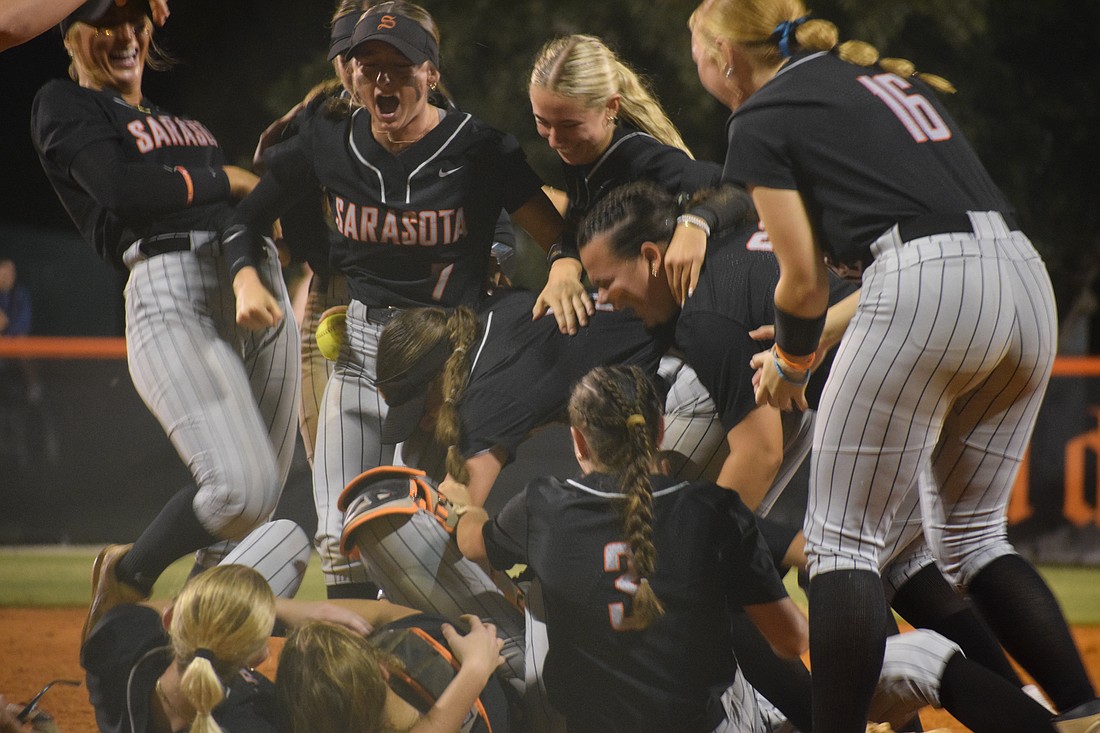 Sarasota softball dog-piled in the pitcher's circle after securing the final out against Riverview Sumner on May 15.