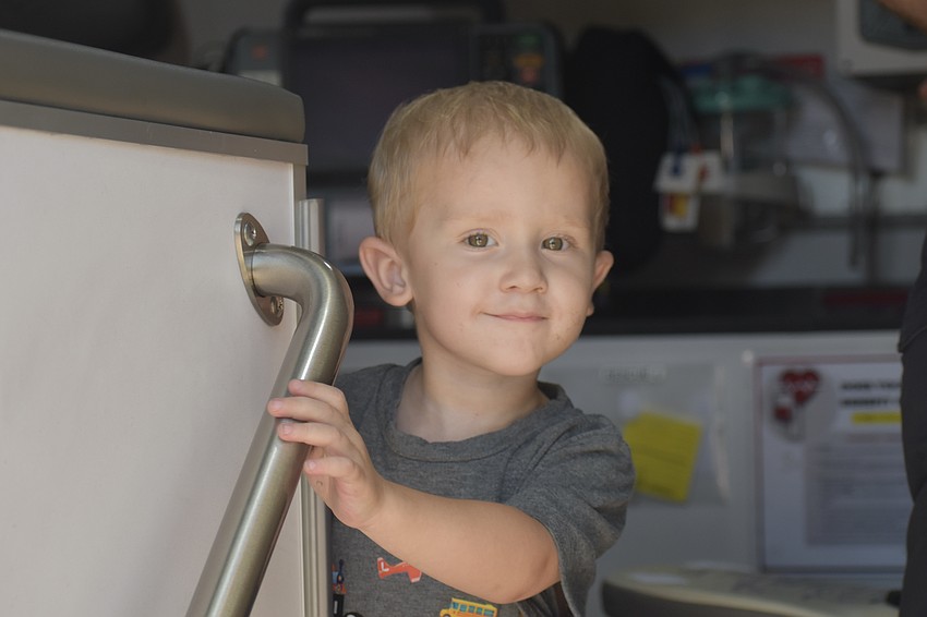Mason Kohn, 3, explores an ambulance.