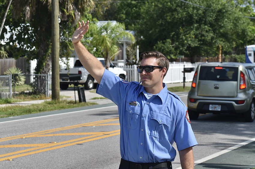 Dakota Haberland waves to passerby on the road.