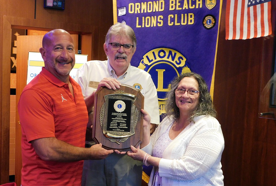 Ormond Beach Lions Club president Dennis Sweeny (center) and Lions Club Seabreeze Athletes of the Month administrator Jeanette Oberst presents the 2024 Athletes of the Month plaque to Seabreeze athletic director Anthony Campanella. Courtesy photo