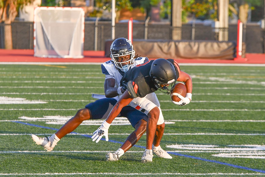 Dr. Phillips defensive back Mchenry Fortilien (No. 6) made a tackle in the Panthers’ spring game win over Winter Park High.