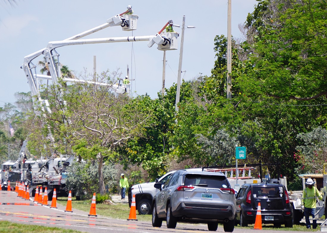 Construction crews work on removing the last group of overhead wires and poles before summer 2025.