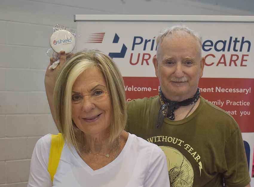 Janet Tibbetts and Chris Joyce make their way around to the informational booths provided. Joyce says he is sampling cookies and resources and appreciates that he can find so many resources in one place.