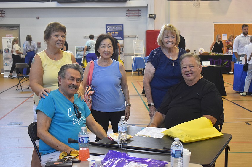 Visitors at the senior fair take a break from learning about senior living options and products regarding wellness and healthcare.