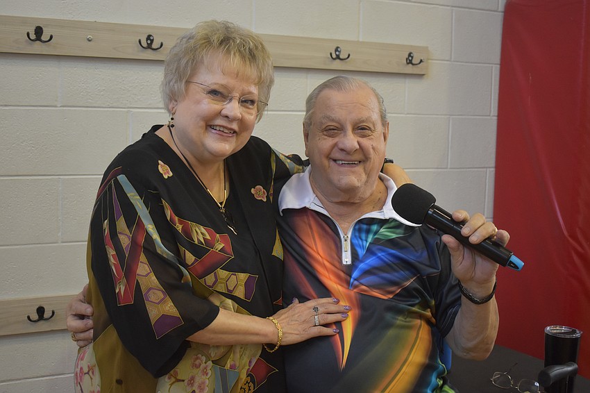 Chuck and Phyllis Lynn, owners of Lynn's Spins Inc. provide entertainment for the senior fair. Phyllis controls the music while Chuck sings. They will celebrate their 57th wedding anniversary on May 24.