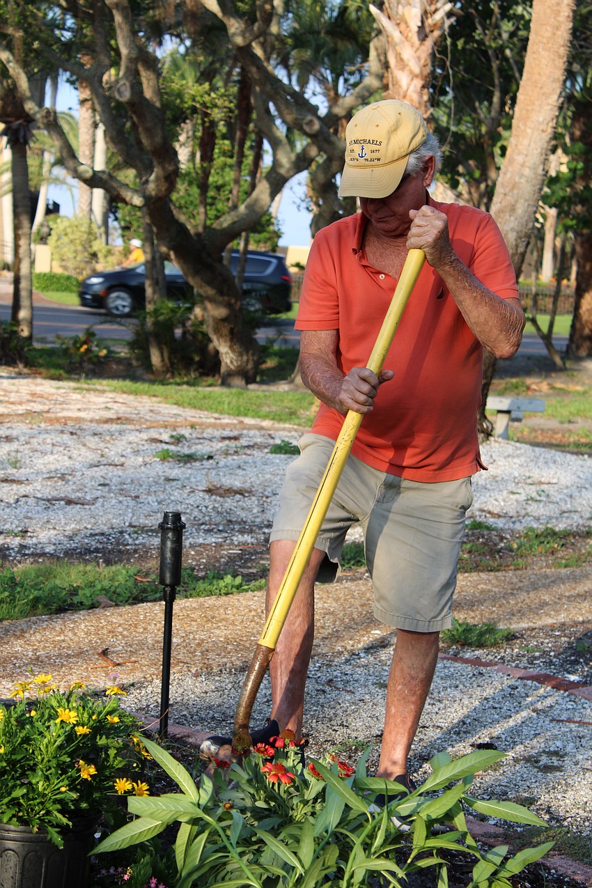 Jim Brown sets to work digging up the soil in the Butterfly Garden.