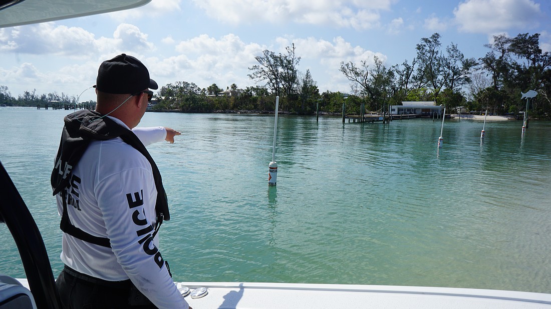 Officer Dallas Troyer points out the buoys that clearly mark the vessel exclusionary zone. Still, the area is a problem for the marine patrol unit.