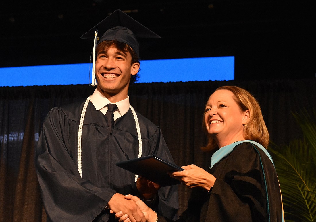Head of school Debra Otey congratulates co-salutatorian Josey Rubinstein on graduating. Rubinstein was honored as a U.S. Lacrosse All-Academic American, signifying excellence in academics and athletics.