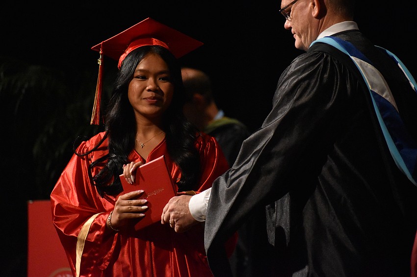Ava Truong receives her diploma from Principal Ben Hopper.