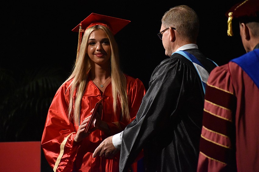 Olivia Wolszczak walks the stage with her diploma.