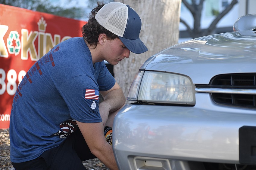 Preston Kehs, 18, is the son of Rob Kehs and founded P&E Auto Detailing with Evan Eckert, fixes up the car for veteran Gerry Jones.