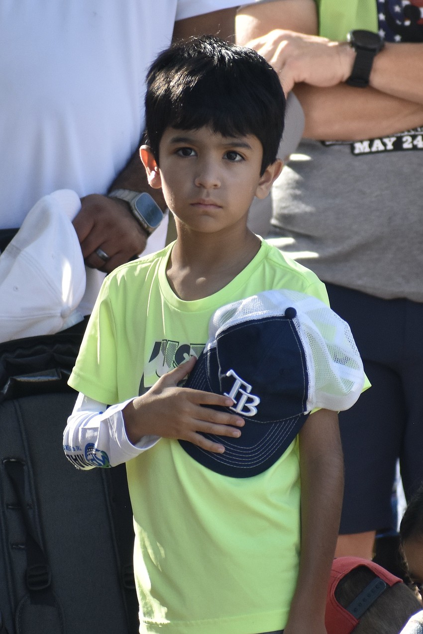 Zeke Perez, 7, participates in the ceremony.