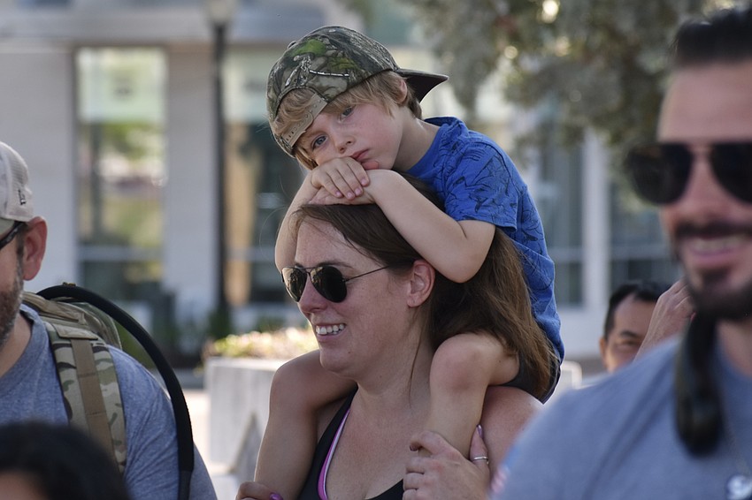 Emily Huetten carries her son Tyler Huetten, 4.