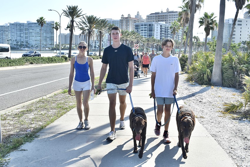 Kelly Westover and her children Zach Westover, 19, and Nathan Westover, 15, walk the family's dogs Blue and Marlin.