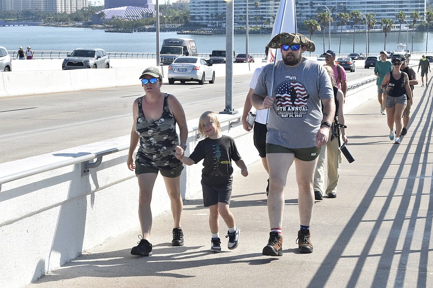 Jean Stegmeier, her son Carson Stegmeier, 7, and husband Rick Stegmeier walk up the Ringling Bridge.