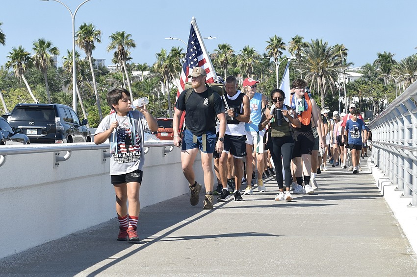 Walkers head back across the Ringling Bridge, with Leo Sterbinsky, 9, in front.