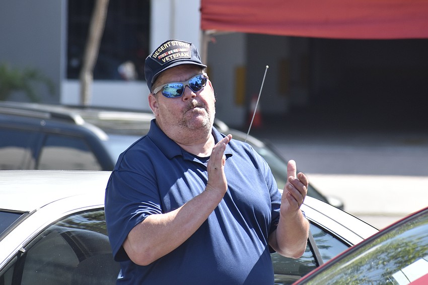 Navy and Marine Corps veteran Gerry Jones applauds as he receives his car.