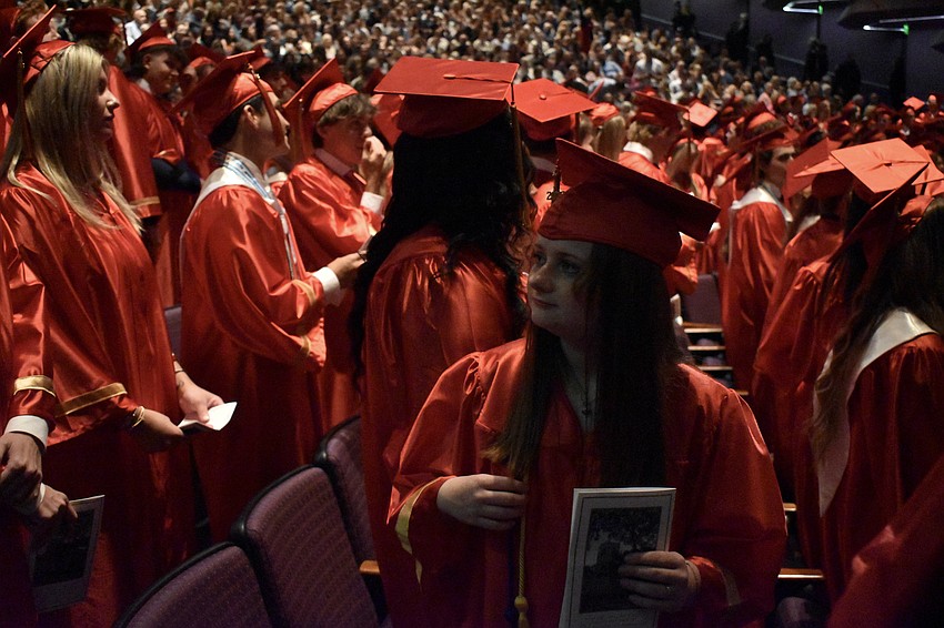 Brooke Johnson looks up as students walk the aisle to fill the seats.