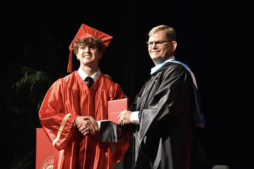 Nolan Bessé receives his diploma from Principal Ben Hopper.