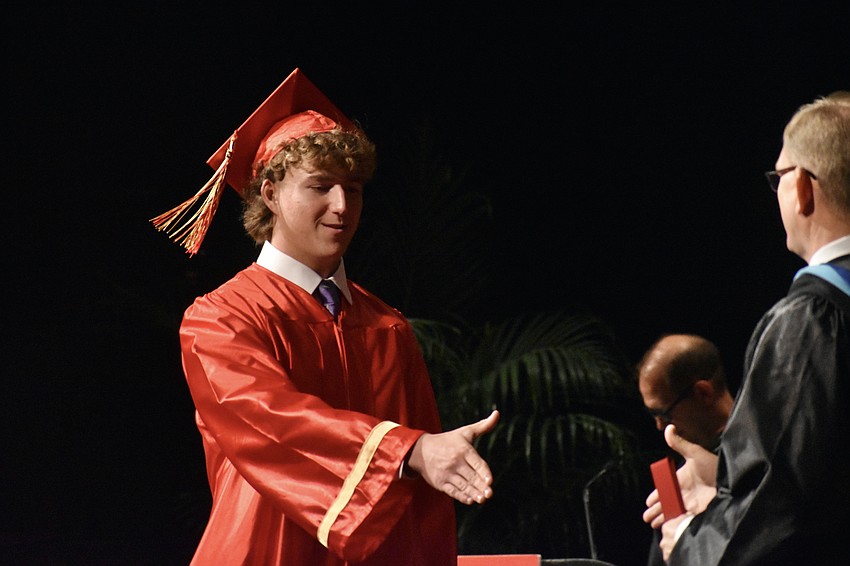 Browning Collison shakes hands with Principal Ben Hopper.