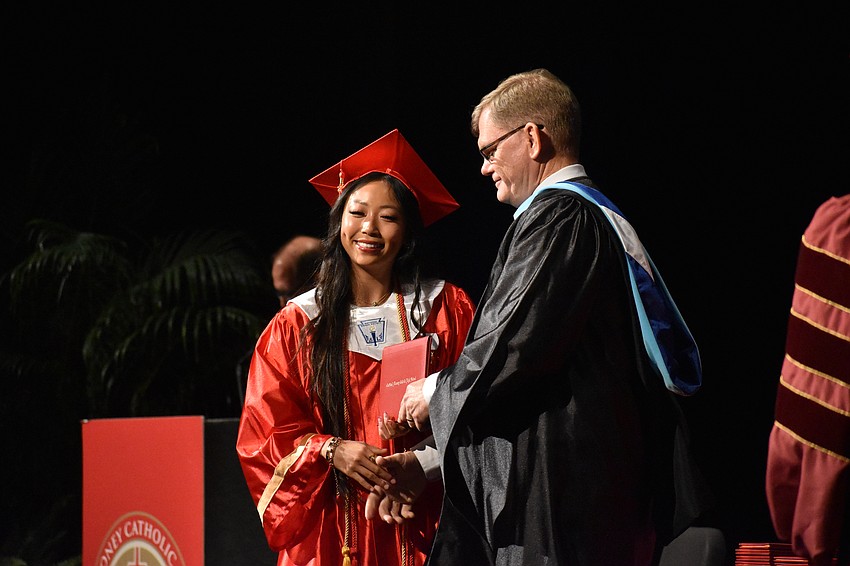 Mischa Doan shakes hands with Principal Ben Hopper.