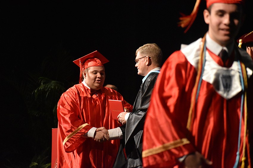 Dalton Fleming shakes hands with Principal Ben Hopper.