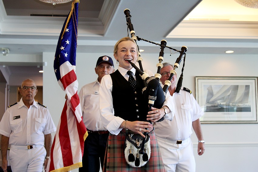 Gemma Briggs plays the bagpipes while accompanied by Rear Commodore Saul Landesberg, Jay Plager and Vice Commodore Tony Britt during Bird Key Yacht Club's tribute to the fallen for Memorial Day.