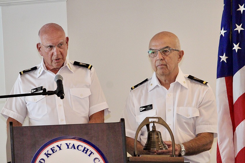 Bird Key Yacht Club Commodore Michael Landis and Rear Commodore Saul Landesberg ring a bell in tribute to American soldiers who died in battle.