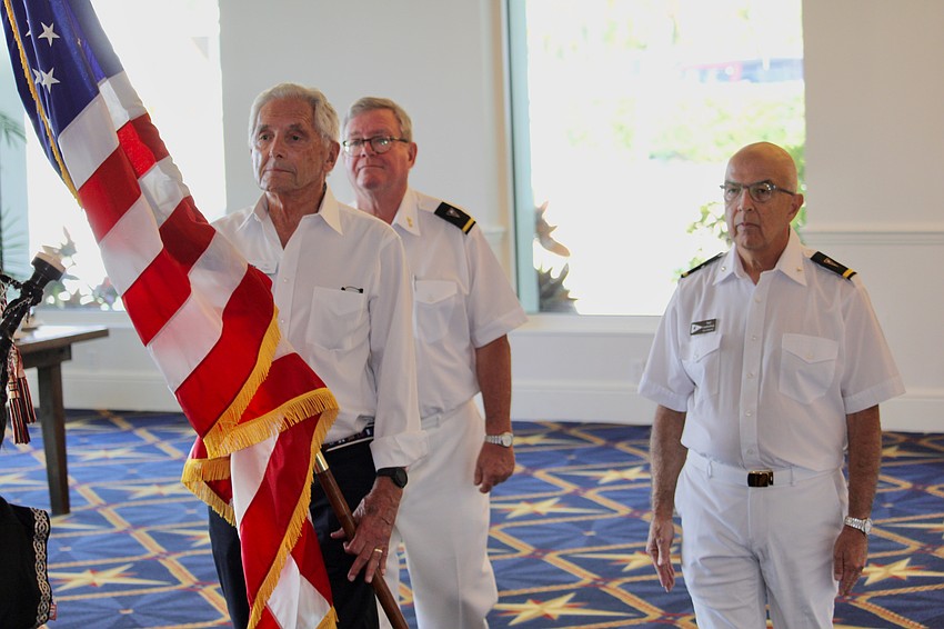 Bird Key Yacht Club Rear Commodore Saul Landesberg, Jay Plager and Vice Commodore Tony Britt retire the colors.