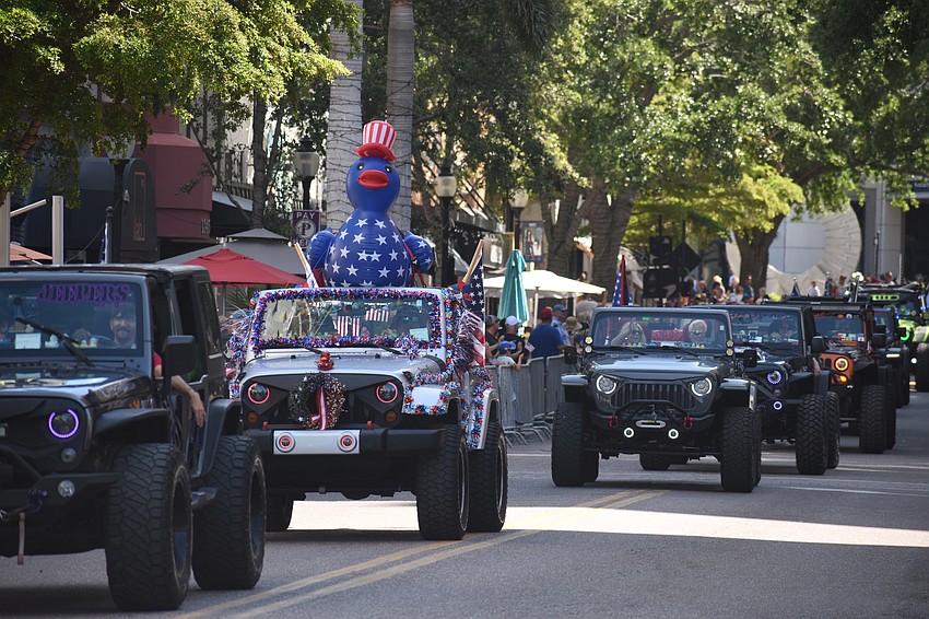 Jeeps make their way down Main Street.