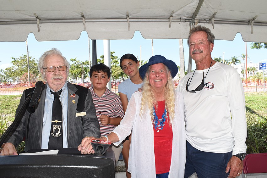 Sonny Bywaters stands with Ivey Coletti, 12, her brother Elijah Coletti, 10 and her grandmother Jan Solomon and grandfather Tim Solomon. Jan Solomon's father was Chaplain J.D. Hamel, for whom J.D. Hamel Park, where the ceremony was held, is named.