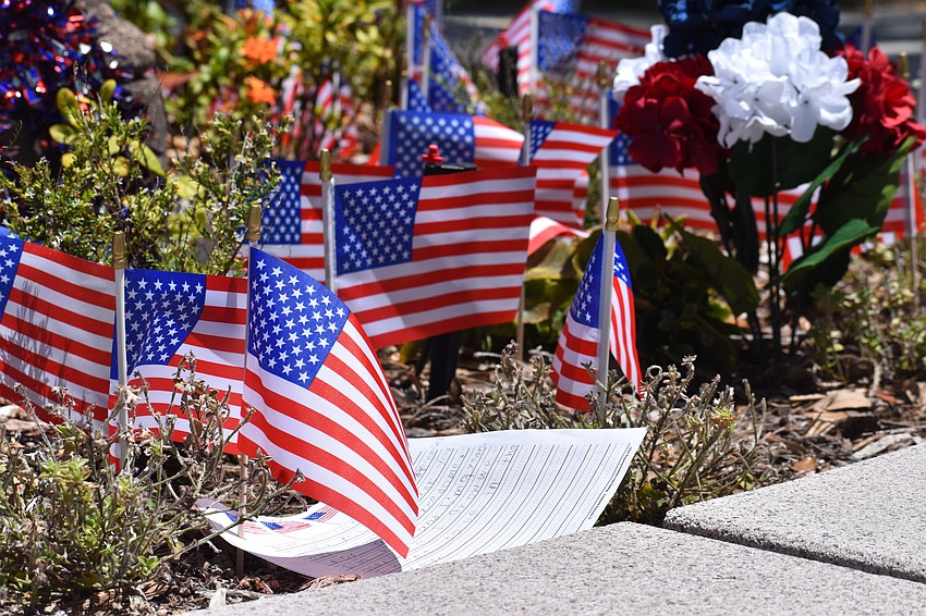 Flags are placed around the war memorial at J.D. Hamel Park.