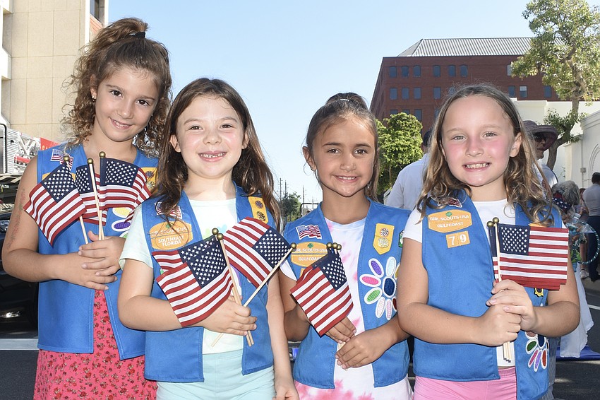 Idil Ata, Defne Moses, Emberley Custode, and Gracie Lynn, 7, of Girl Scouts Troop 79, handed out flags during the event.