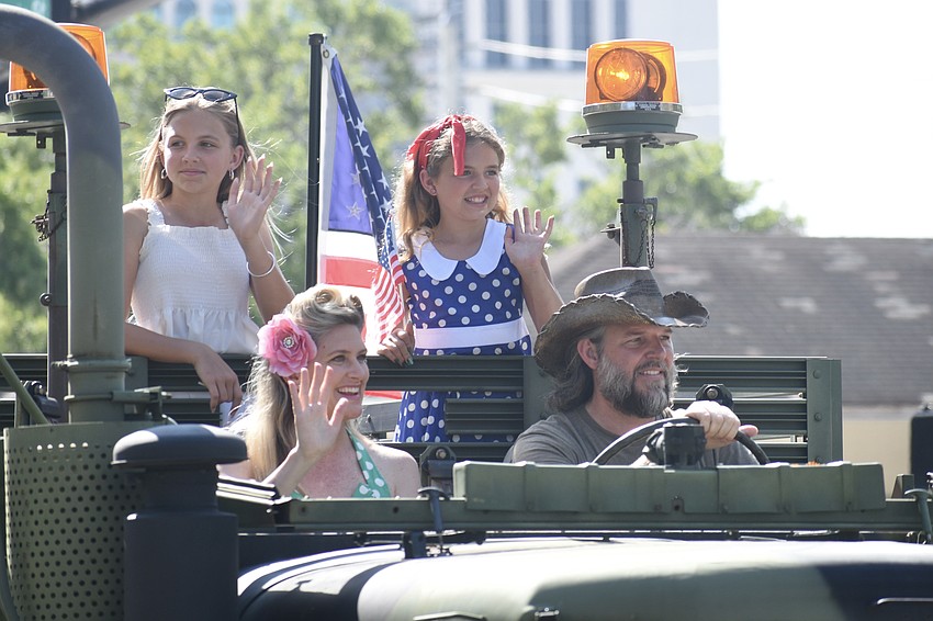 Emma Serrone, 11, her mother Kate Serrone, sister Charlotte Serrone, 9 and father Joe Serrone ride in a troop handler formerly deployed in Iraq, with the Florida Military Vehicle Heritage Group.