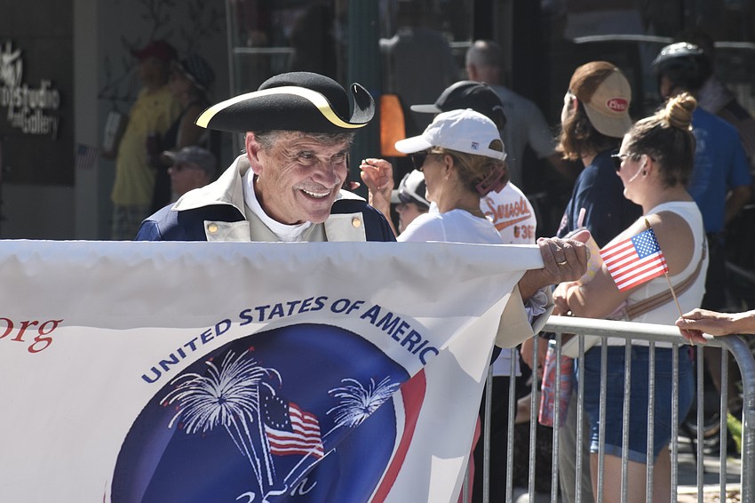 Wallace Hoppe, of Sons of the American Revolution, walks the parade route.