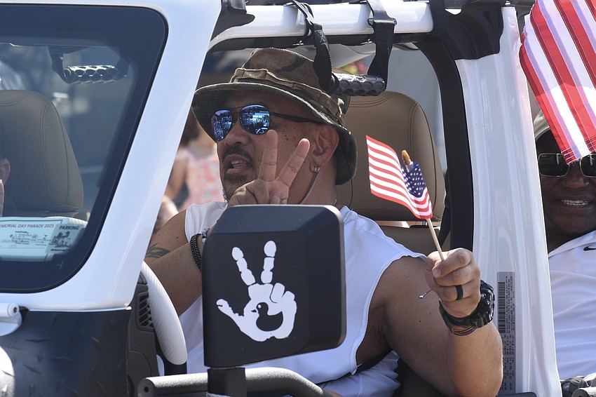 Patrick Barbaza drives by in a jeep.