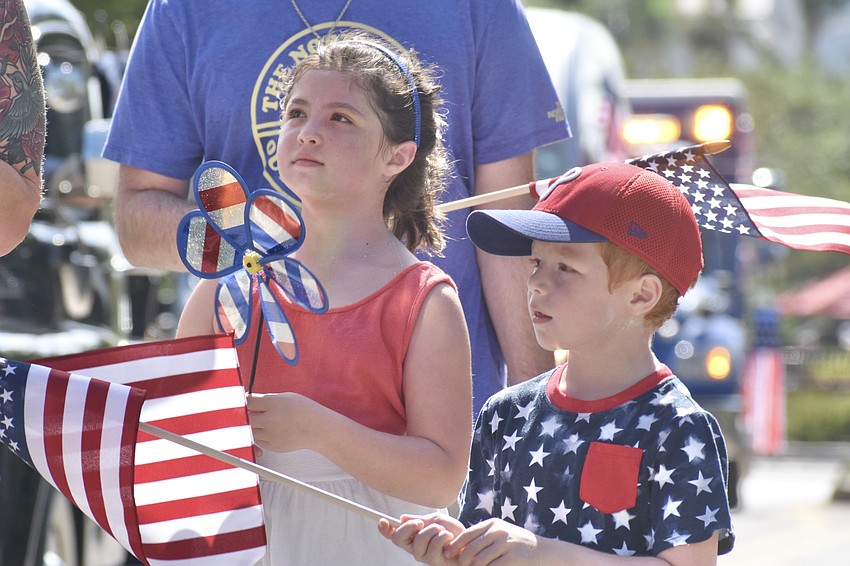 Harlow Swerdlow, 7, and her brother Oscar Swerdlow, 6, walk in the parade.