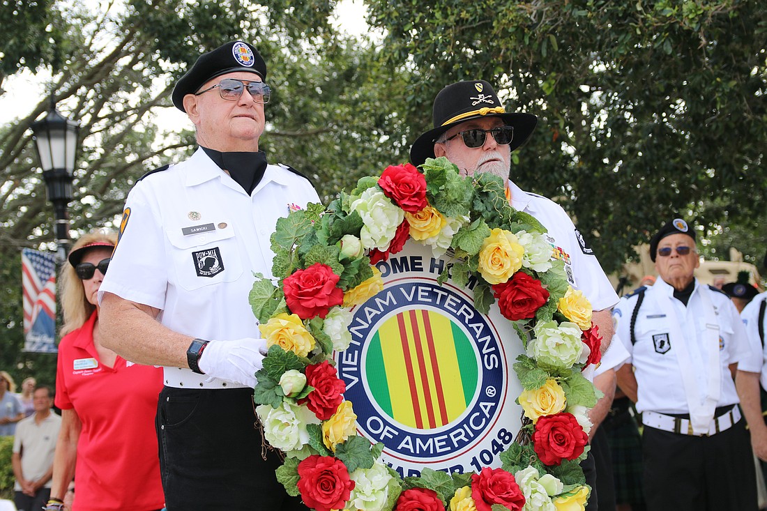 Vietnam Veterans of American Chapter 1048 President Richard Sawicki and President Emeritus Bob Adkins carry a ceremonial wreath during the Ormond Beach Memorial Day Remembrance Service on Monday, May 26. Photo by Jarleene Almenas