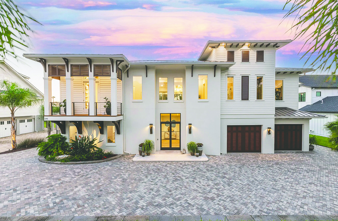 Marshfront home features four bedrooms, four full and one half-bathrooms, guest suite, porches, elevator, outdoor kitchen and pool.