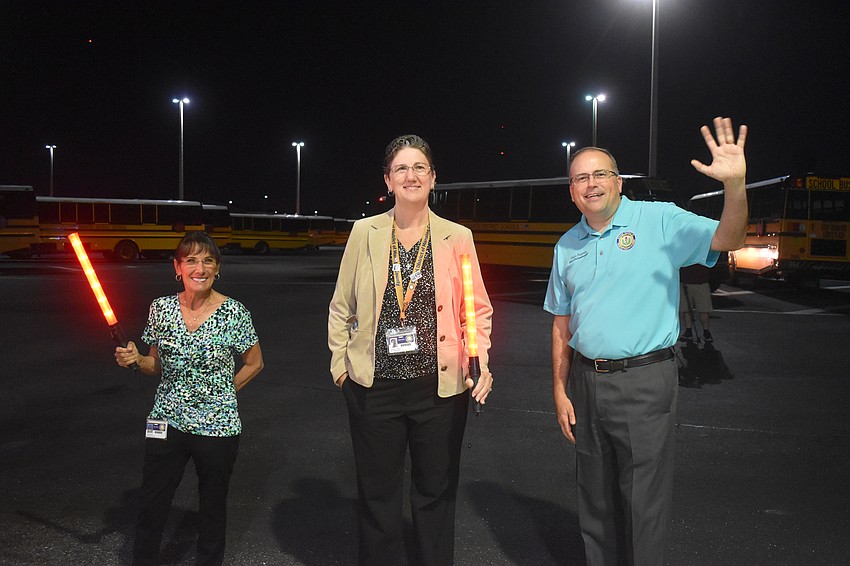 School Board Members Cindy Spray and Heather Felton wave off the bus drivers along with interim superintendent Kevin Chapman.