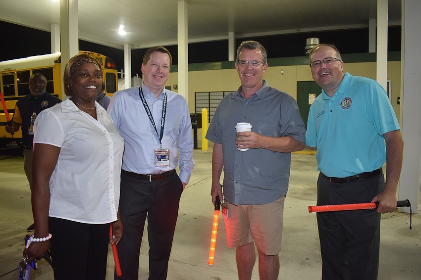 Melanie Johnson, assistant director of transportation, Derek Jensen, deputy superintendent of instruction, School Board Member Charlie Kennedy and Interim Superintendent Kevin Chapman had fun wishing the bus drivers a good last day of school Thursday.
