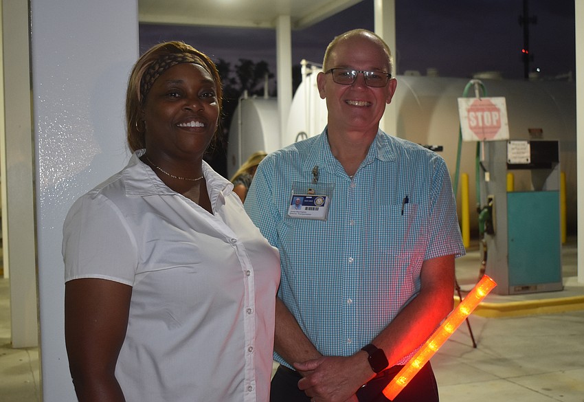 Melanie Johnson, assistant director of transportation, and Jamie Warrington, director of transportation, wave to their drivers Thursday on the last day of the 2024-2025 school year.