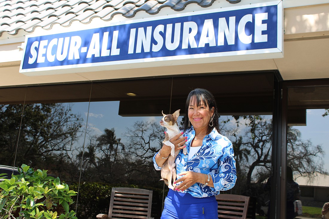 Sandra Smith and Ziggy, the firm's official public relations specialist, get settled after Secur-All Insurance's relocation to 510 Bay Isles Road.