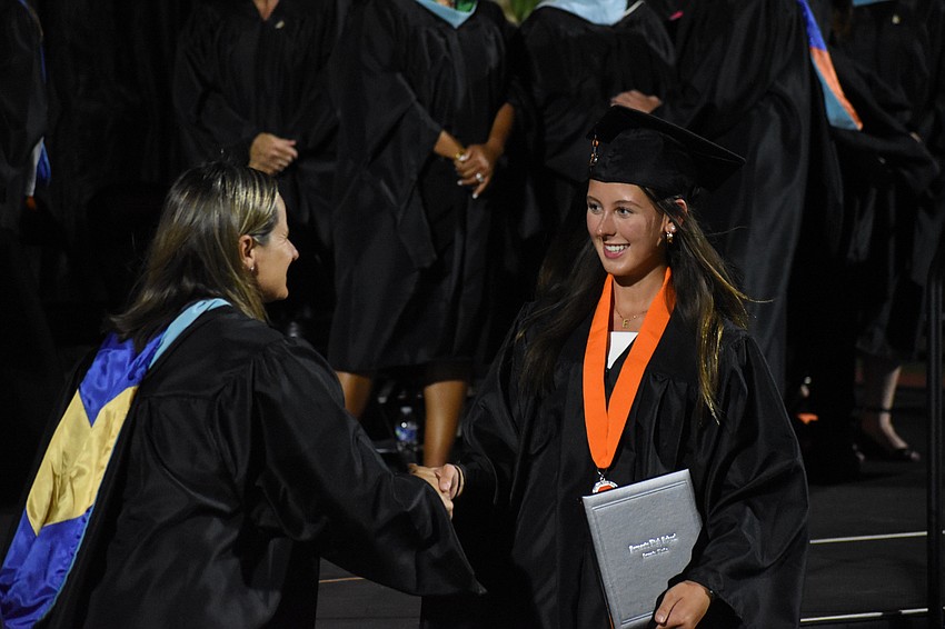 Assistant Principal Lindsay Gallof greets Emma Zamikoff.
