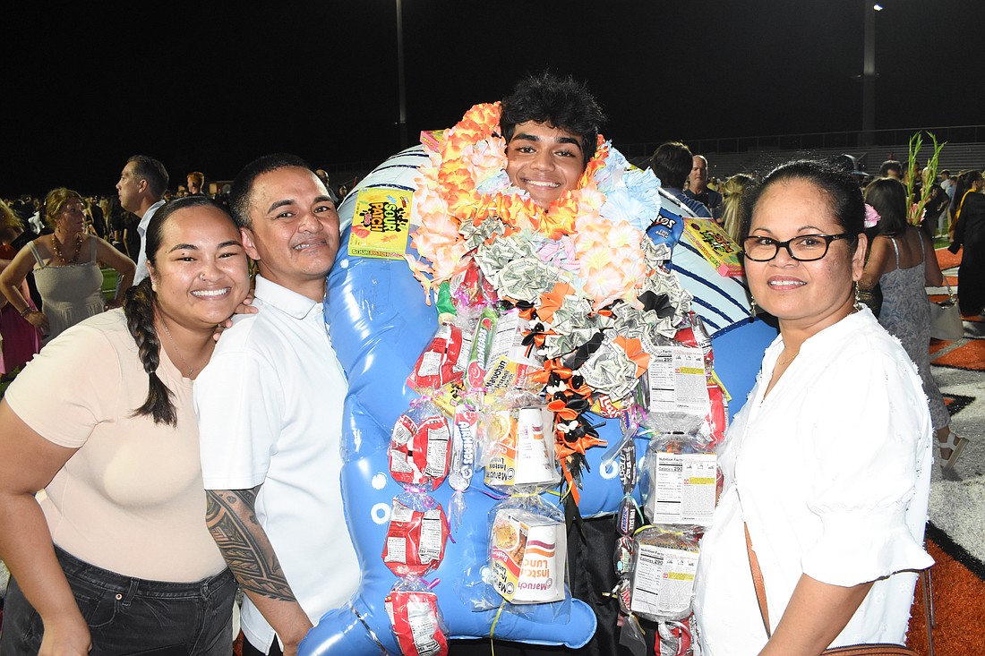 Jacob Kalua (second from right) celebrates with his sister Regan Kalua, father Shelton Kalua and mother Regina Kalua after graduating Sarasota High School.