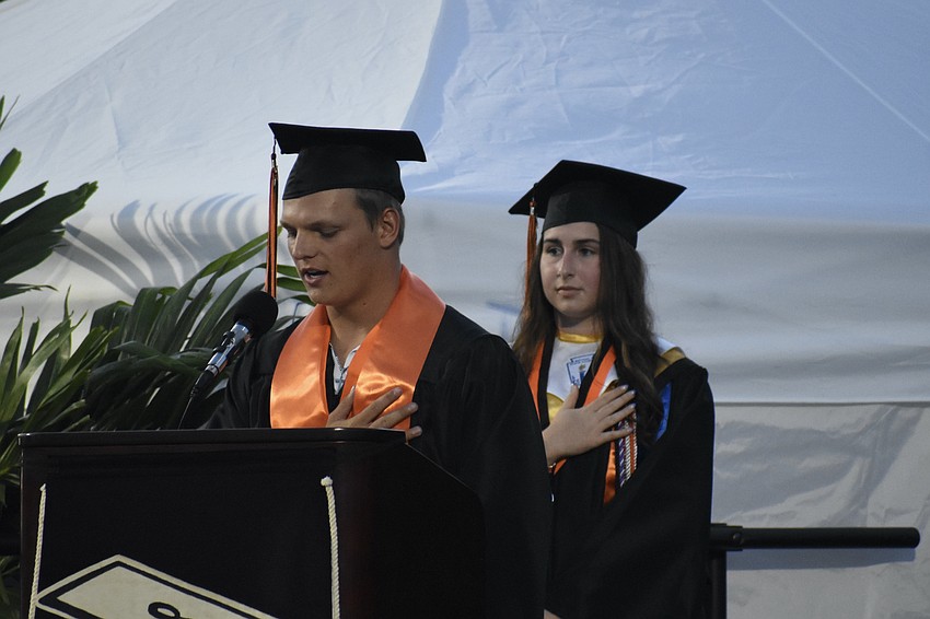Cameron Ehrlich leads the Pledge of Allegiance, standing in front of Ella Collier, which was translated in sign language by Jazaria McCoy.