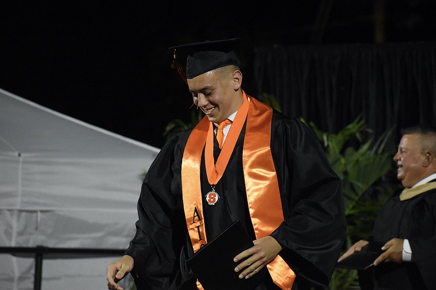 Jake Brascgalla descends the steps after receiving his diploma.