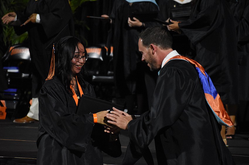 Kelly Capiz greets Principal Ryan Chase.