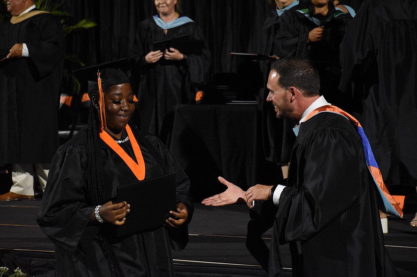 Quantieria Dailey greets Principal Ryan Chase.