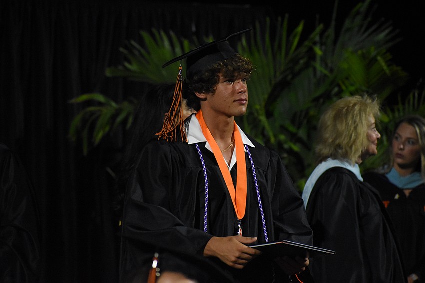 Vince Oser walks across the stage.